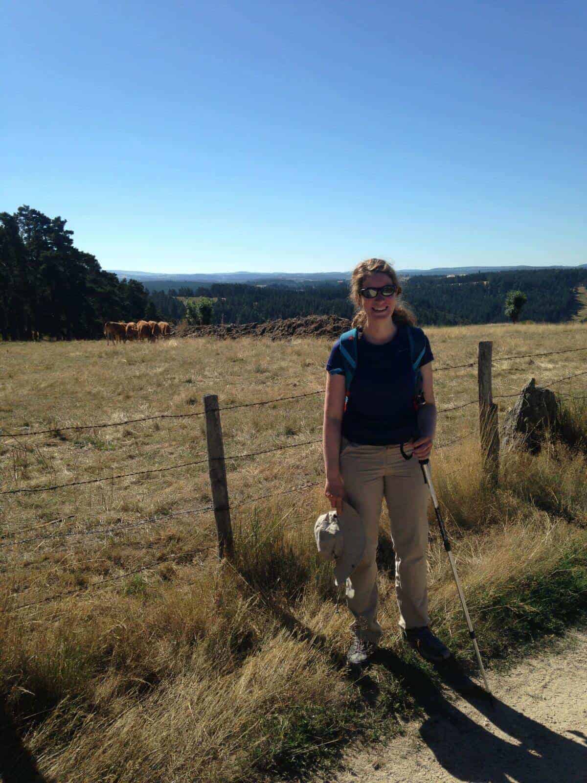 A woman on a hike in the countryside.