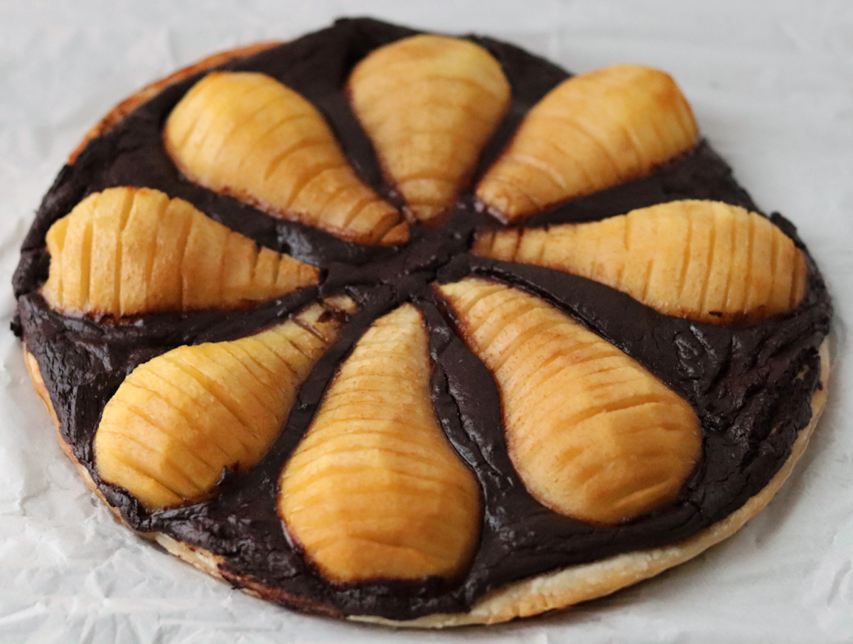 pear and chocolate tart on a white sheet