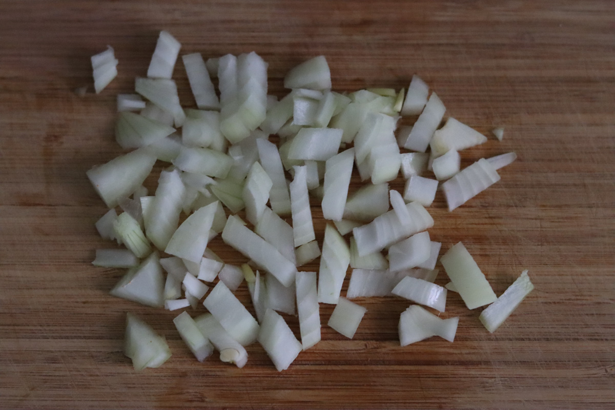 diced onion on a wooden board