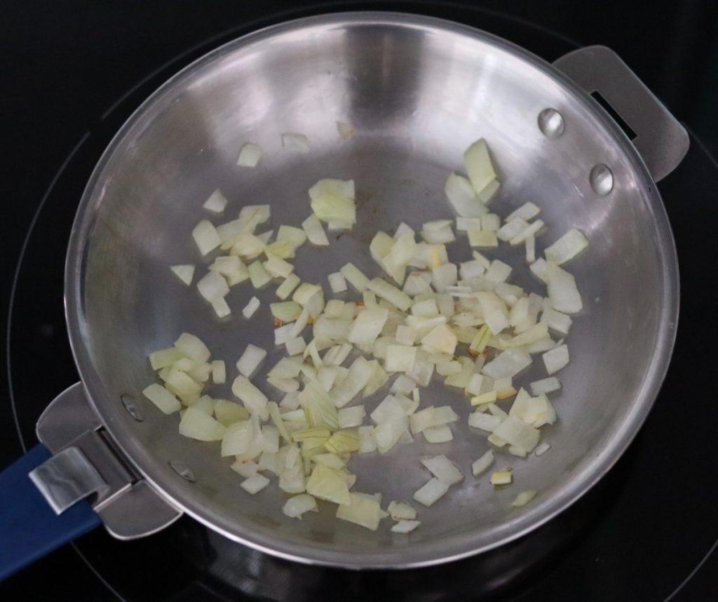 diced onion cooking in a skillet