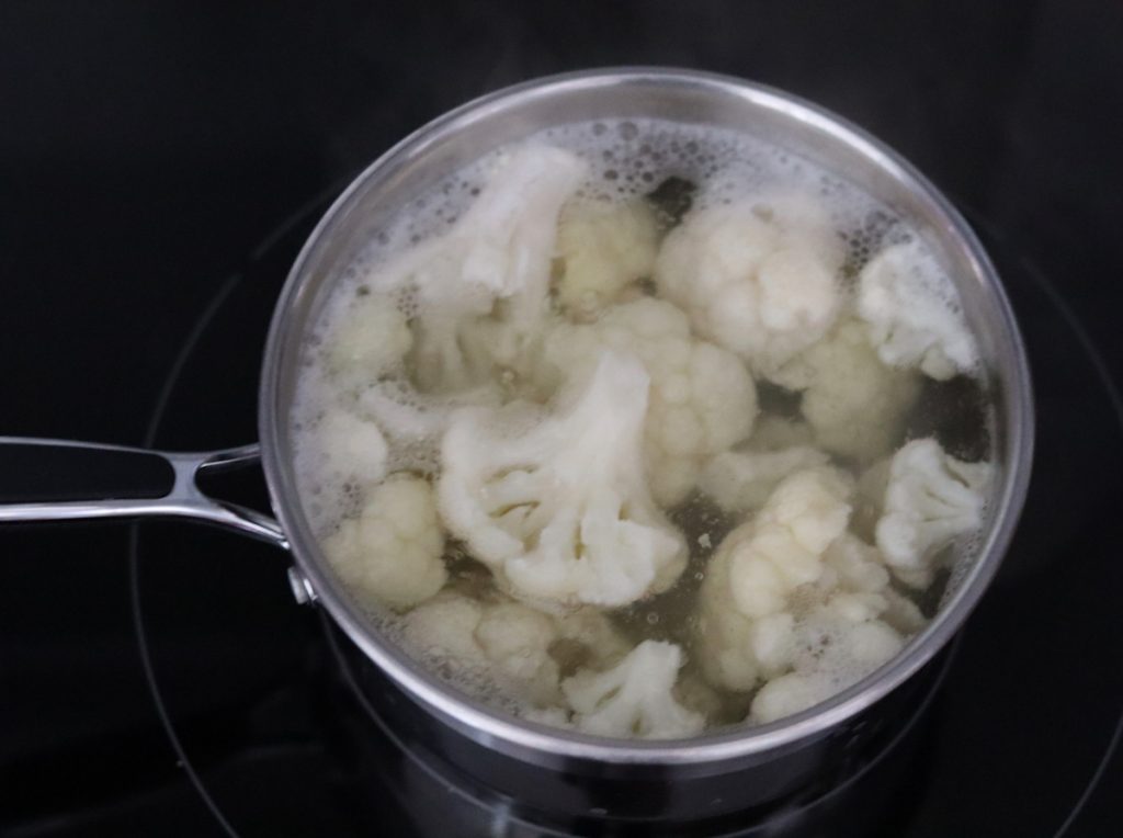 cauliflower florets ccoking in boiling water