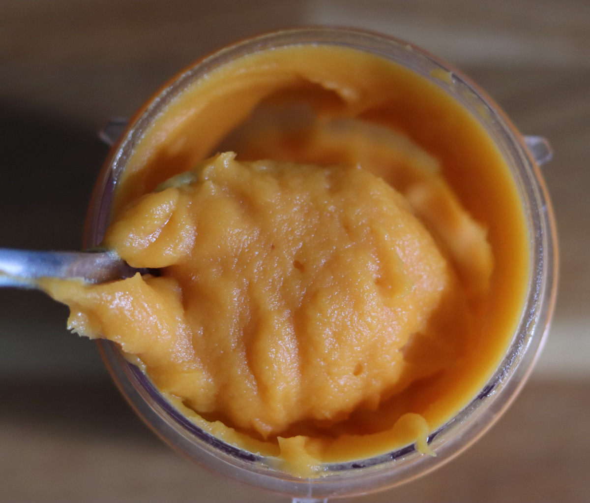 a spoonful of sweet potato purée taken form a blender