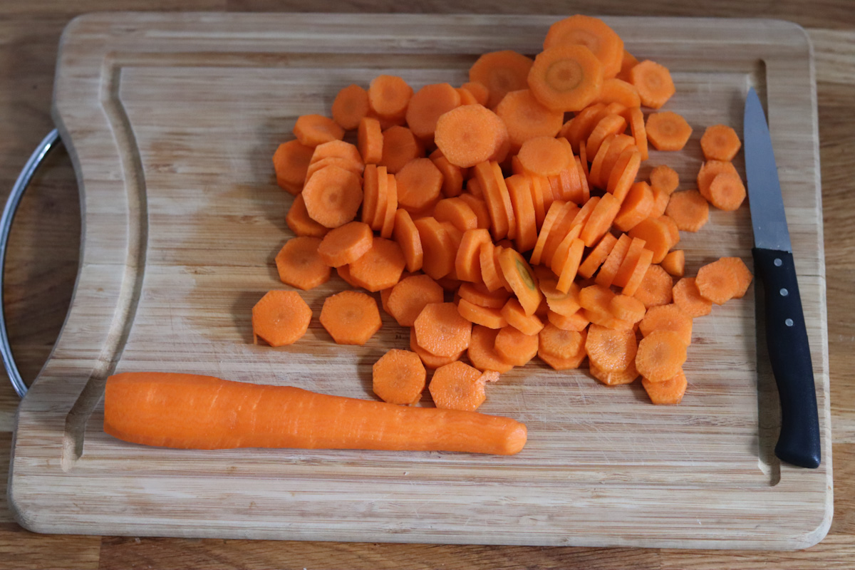 carrots sliced in coins on a wooden board