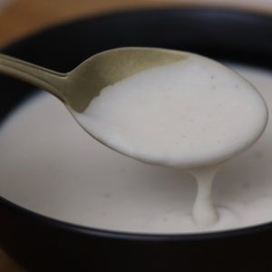 Vegan and gluten free Bechamel sauce in a black bowl