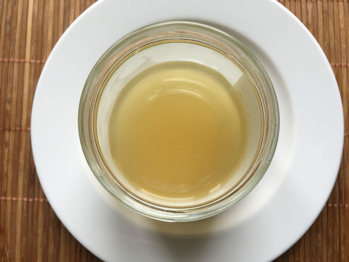 aquafaba dans un pot en verre sur une assiette blanche