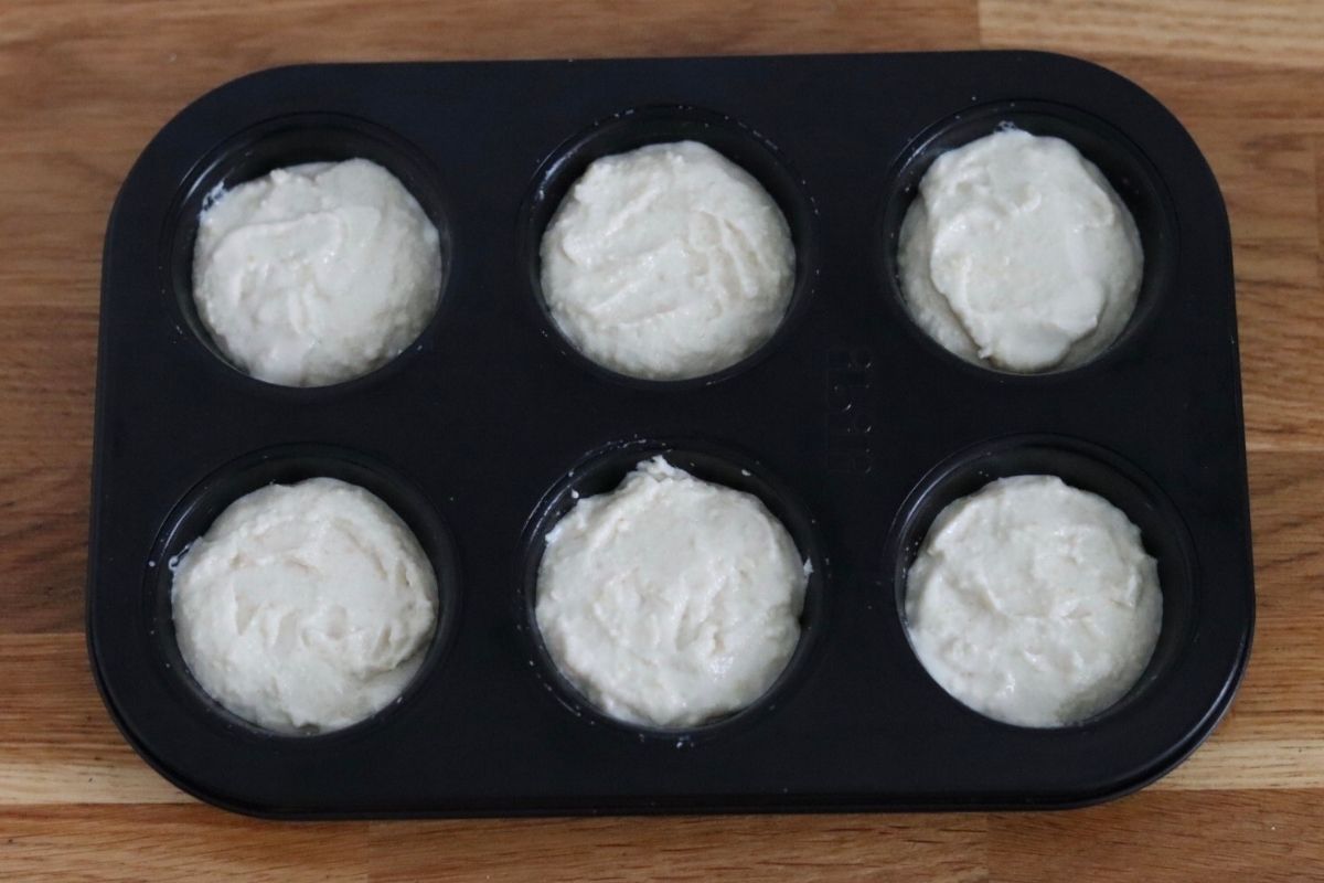 the biscuit batter in 6 muffin cups of a muffin pan