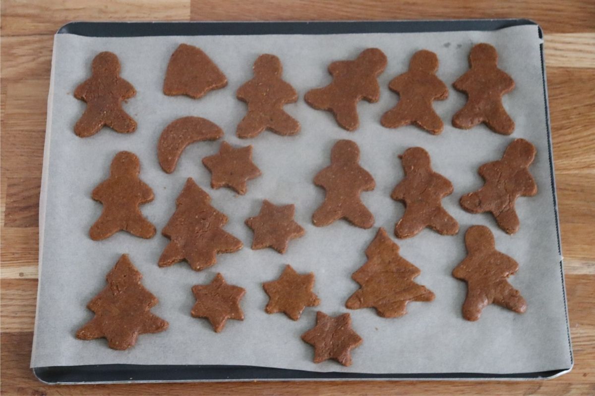 gingerbread cookies of different shapes on a baking tray