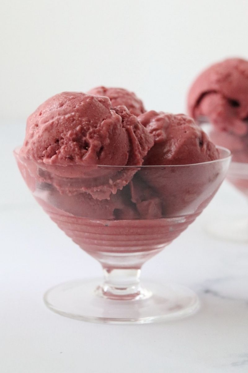 a glass filled with red velvet ice cream and a second one in the background