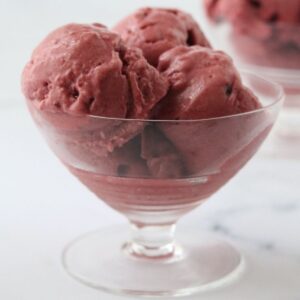 a glass filled with red velvet ice cream and a second one in the background