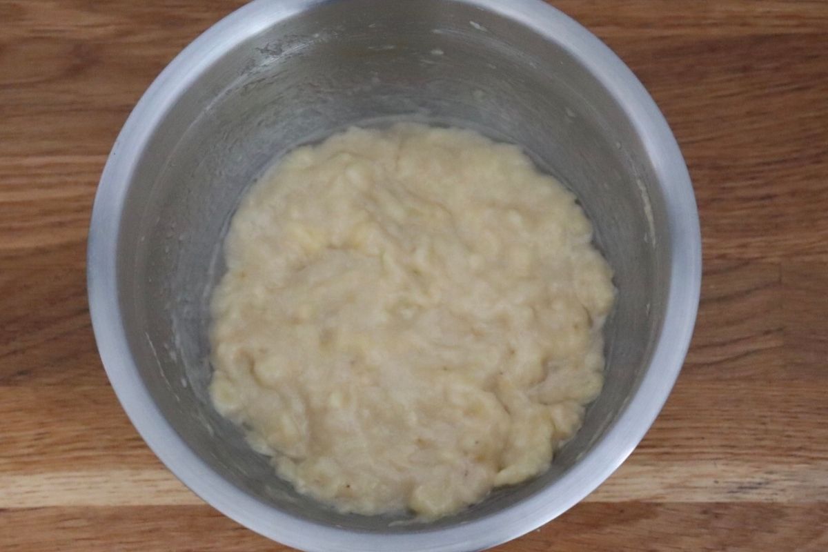 bananas mashed together with coconut oil in a mixing bowl