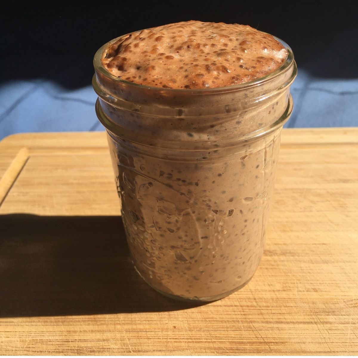 tapioca pudding in a glass jar on a wooden board