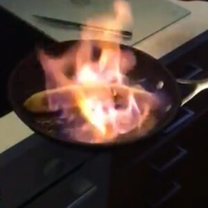 a banana being flambe in a skillet