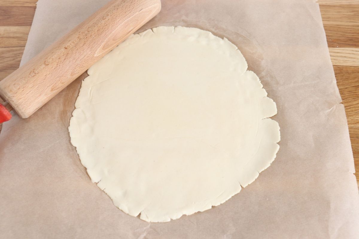 Rolled out dough on a parchment paper.