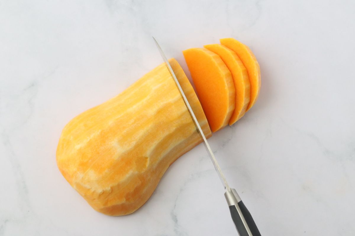 half a butternut squash being sliced