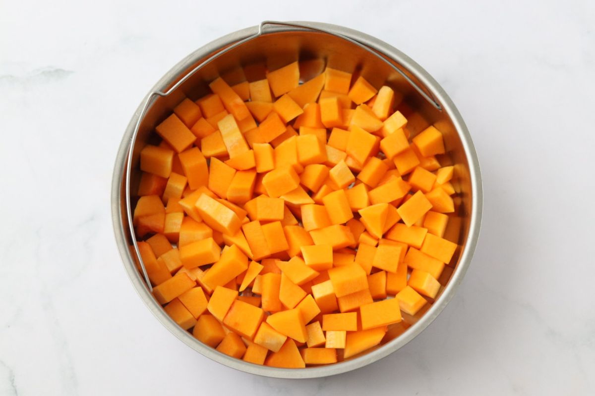 butternut squash cubes in a steamer basket