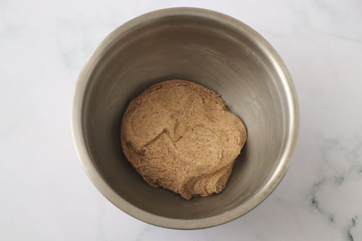 a ball of pie crust dough in a mixing bowl