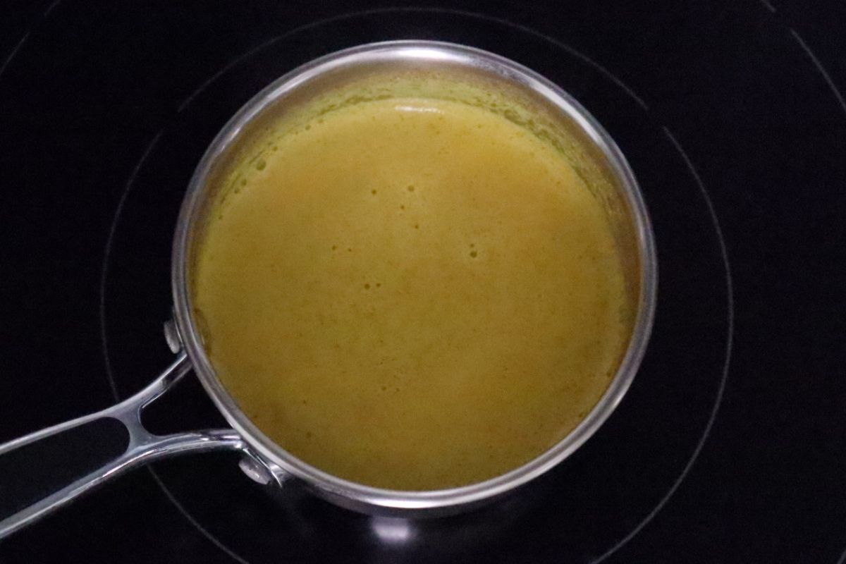 golden milk simmering in a saucepan