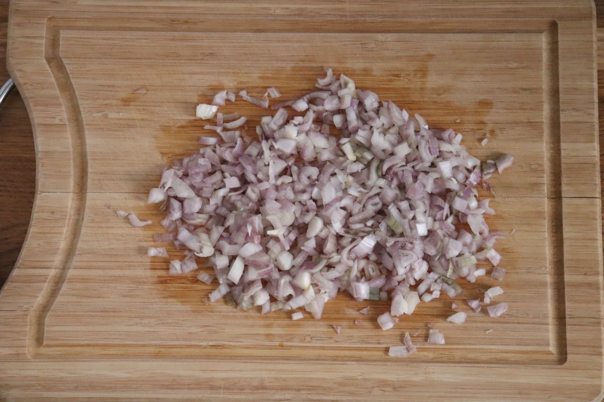 minced shallots on a wooden board