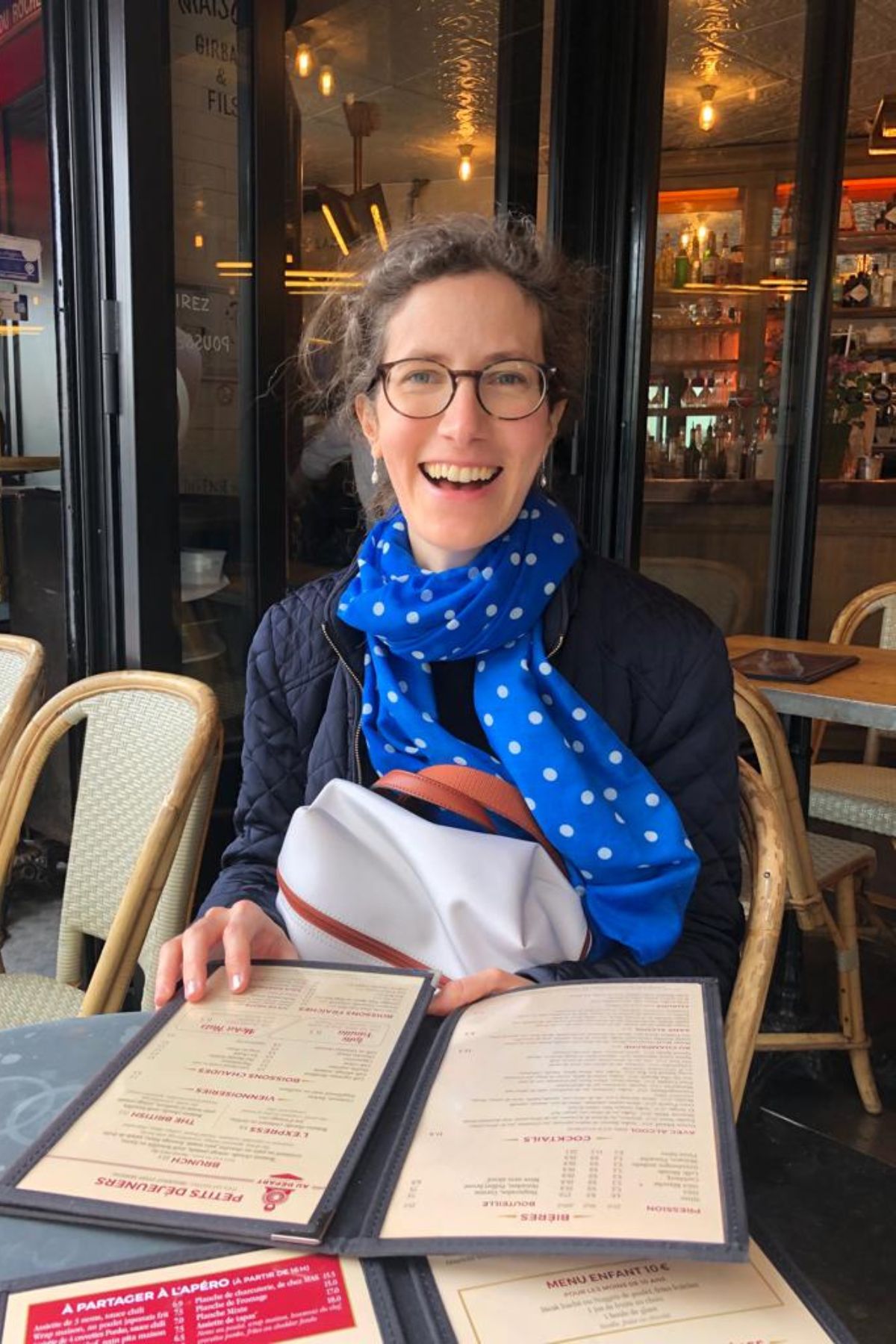 A Parisian woman seated at a restaurant in Paris.