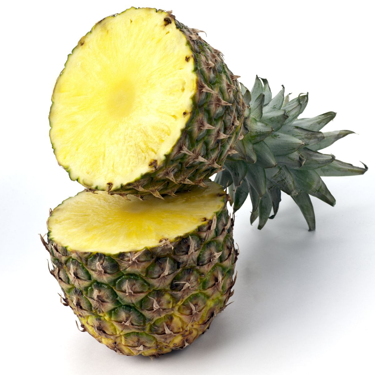 A pineapple cut in half crosswise.