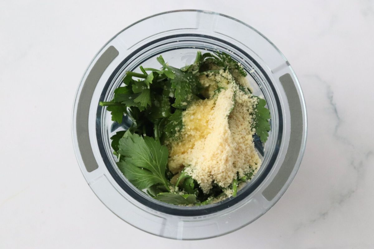 All the parsley pesto ingredients in a small blender.