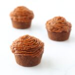 3 muffins covered with carob frosting.