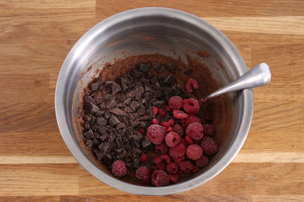 The chocolate chips and frozen raspberries added to the batter.