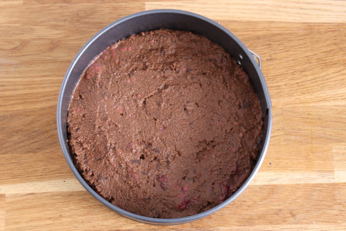 The chocolate raspberry cake batter in a cake pan.