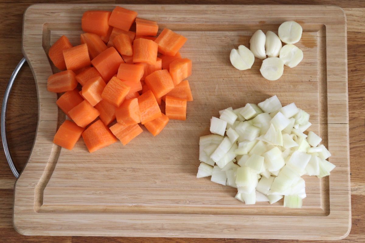 Carrots cut in bite size pieces, diced onion and garlic cloves halved and germ removed.